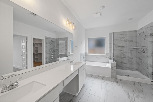 15230 Prairie Mill Dr, New Caney, TX 77357 - bathroom featuring a garden tub, a marble finish shower, double vanity, a spacious closet, and marble finish floors