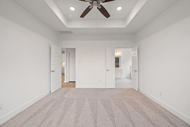 15230 Prairie Mill Dr, New Caney, TX 77357 - unfurnished bedroom with carpet floors, a raised ceiling, recessed lighting, ensuite bathroom, and a ceiling fan