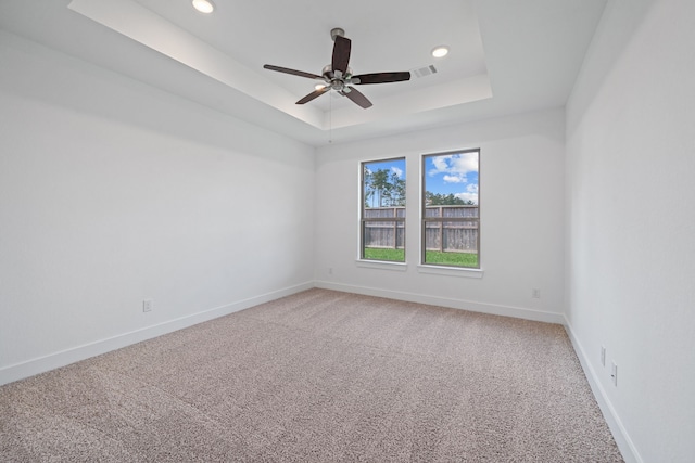 15230 Prairie Mill Dr, New Caney, TX 77357 - unfurnished room with a raised ceiling, light colored carpet, a ceiling fan, and recessed lighting