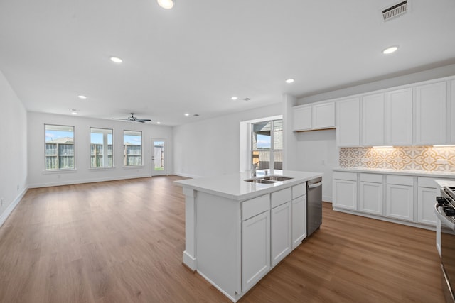 15230 Prairie Mill Dr, New Caney, TX 77357 - kitchen featuring appliances with stainless steel finishes, healthy amount of natural light, light wood-style flooring, recessed lighting, and tasteful backsplash