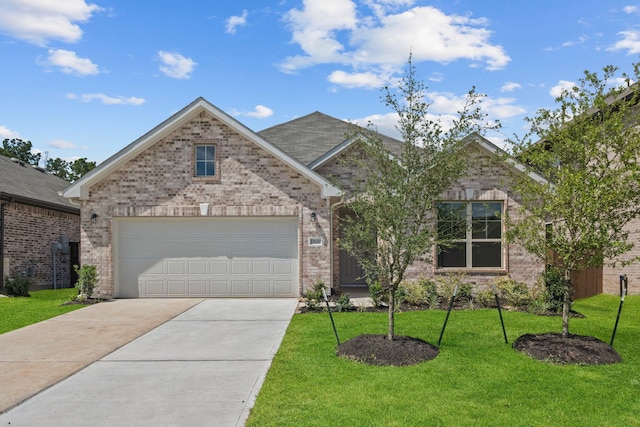 15230 Prairie Mill Dr, New Caney, TX 77357 - view of front facade with concrete driveway, brick siding, a front yard, and an attached garage