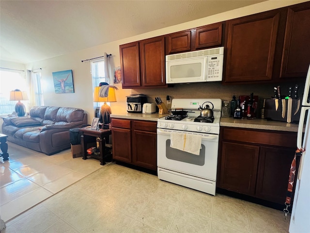5827 Hatfield Glen Dr, Katy, TX 77449 - kitchen with white appliances, light countertops, open floor plan, and light tile patterned flooring