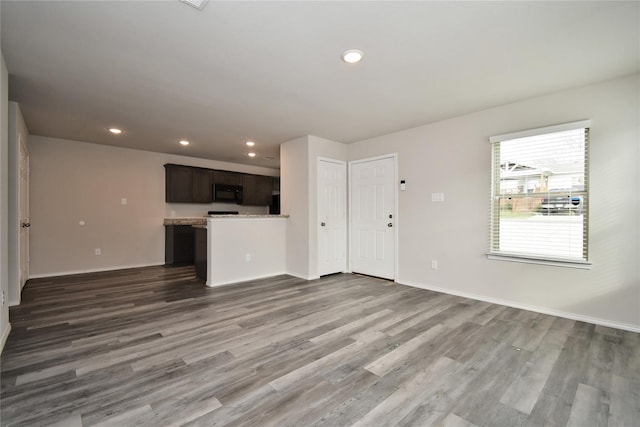 16893 W Forrestal, Montgomery, TX 77316 - unfurnished living room featuring recessed lighting, wood finished floors, and baseboards