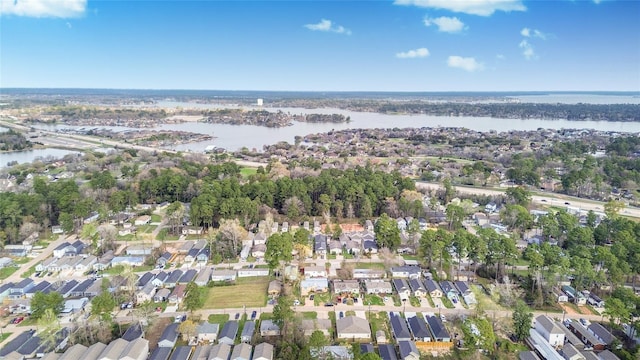 16893 W Forrestal, Montgomery, TX 77316 - aerial overview of property's location with a nearby body of water, nearby suburban area, and a tree filled landscape