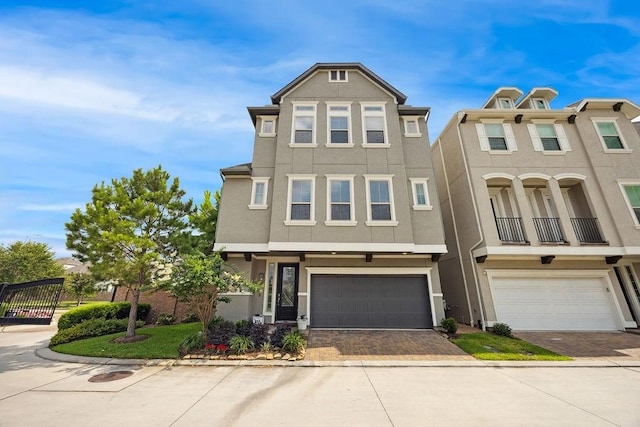 10603 Centre Green Way, Houston, TX 77043 - townhome / multi-family property with stucco siding, a garage, and decorative driveway