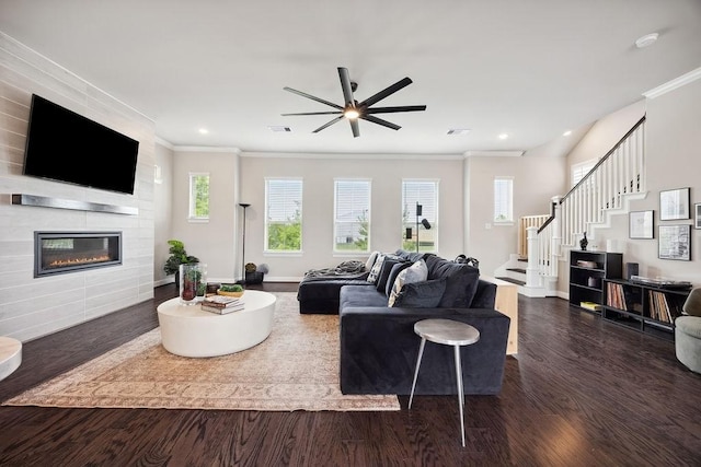 10603 Centre Green Way, Houston, TX 77043 - living area with crown molding, ceiling fan, dark wood-style flooring, a large fireplace, and stairway