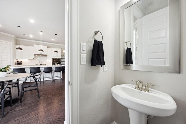 10603 Centre Green Way, Houston, TX 77043 - bathroom featuring crown molding, tasteful backsplash, wood finished floors, a sink, and recessed lighting
