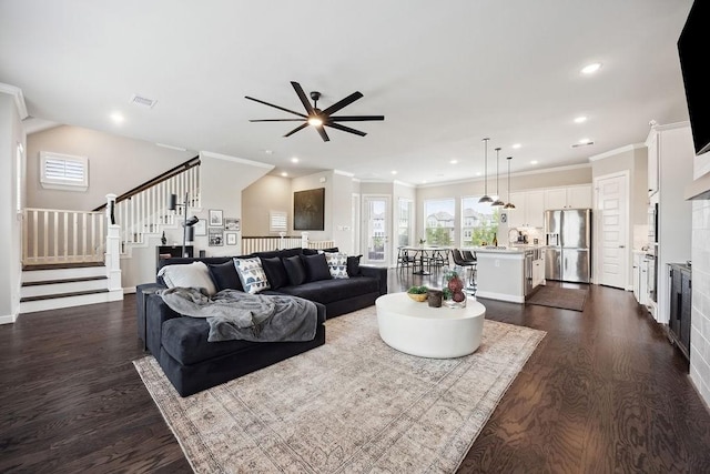 10603 Centre Green Way, Houston, TX 77043 - living room featuring stairway, dark wood-style floors, a ceiling fan, a tiled fireplace, and ornamental molding