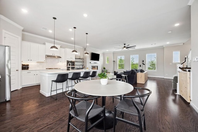 10603 Centre Green Way, Houston, TX 77043 - dining area with crown molding, dark wood-type flooring, ceiling fan, recessed lighting, and baseboards