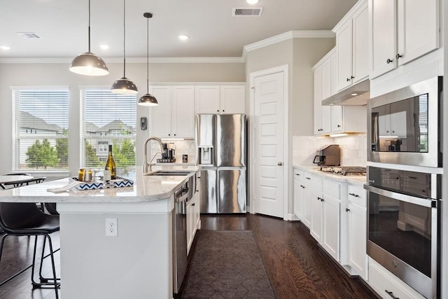 10603 Centre Green Way, Houston, TX 77043 - kitchen featuring stainless steel appliances, dark wood-style flooring, ornamental molding, under cabinet range hood, and white cabinets
