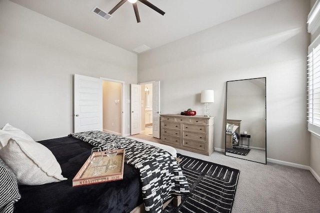 10603 Centre Green Way, Houston, TX 77043 - carpeted bedroom featuring baseboards, a high ceiling, multiple windows, ceiling fan, and ensuite bathroom