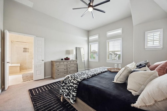 10603 Centre Green Way, Houston, TX 77043 - carpeted bedroom featuring multiple windows, ensuite bath, baseboards, and a ceiling fan