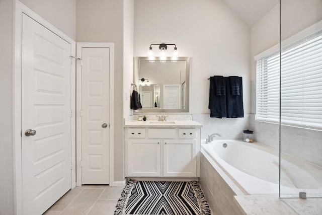 10603 Centre Green Way, Houston, TX 77043 - bathroom featuring a bath, vanity, lofted ceiling, and tile patterned flooring