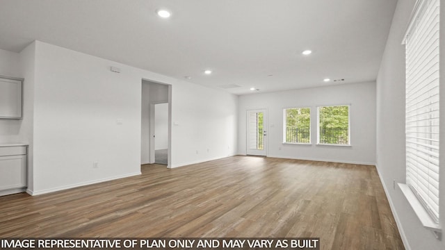 1350 Heather Rosewood Ln, Conroe, TX 77301 - unfurnished living room featuring light wood-style floors, recessed lighting, and baseboards