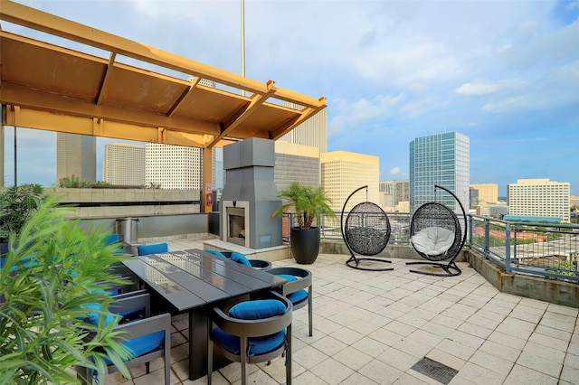 2000 Bagby St Unit 5426, Houston, TX 77002 - view of patio / terrace featuring a multi sided fireplace and a view of city