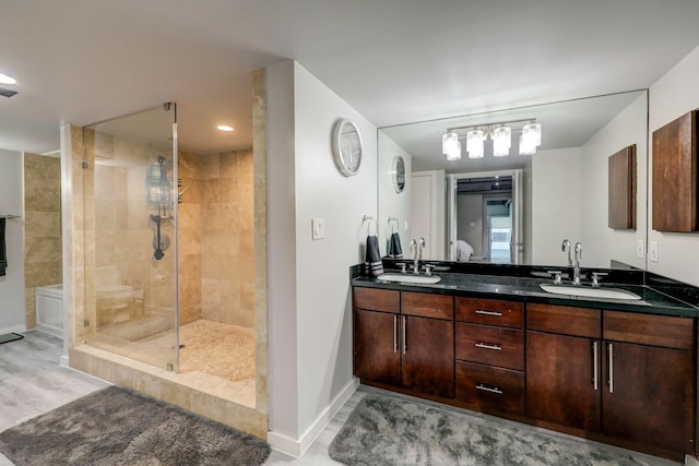 2000 Bagby St Unit 5426, Houston, TX 77002 - full bathroom featuring a tile shower, double vanity, baseboards, and wood finished floors