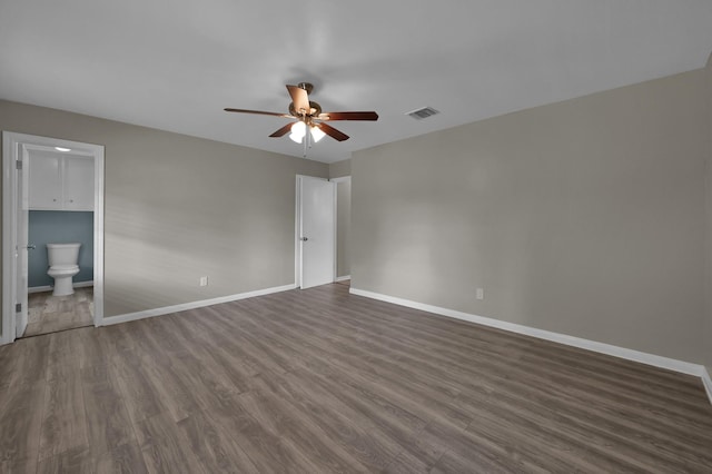 1614 Sweet Grass Trl, Houston, TX 77090 - unfurnished bedroom featuring dark wood-type flooring, baseboards, connected bathroom, and ceiling fan