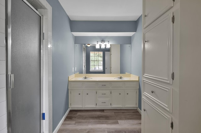 1614 Sweet Grass Trl, Houston, TX 77090 - bathroom with wood finished floors, double vanity, a stall shower, and baseboards