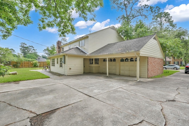 1614 Sweet Grass Trl, Houston, TX 77090 - view of home's exterior featuring a garage, driveway, a chimney, roof with shingles, and brick siding