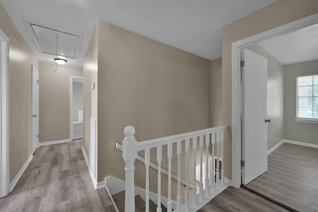 1614 Sweet Grass Trl, Houston, TX 77090 - hallway featuring an upstairs landing, attic access, wood finished floors, and baseboards