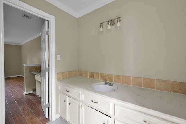 1614 Sweet Grass Trl, Houston, TX 77090 - bathroom with a sink, ornamental molding, wood finished floors, and baseboards