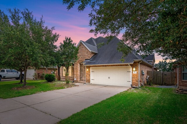 28523 Kinglet Pines Dr, Katy, TX 77494 - traditional home featuring a garage, driveway, brick siding, and a shingled roof