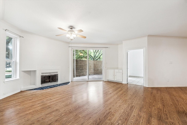 5210 Weslayan St Unit 112, Houston, TX 77005 - unfurnished living room featuring a ceiling fan, a fireplace, wood finished floors, baseboards, and ornamental molding