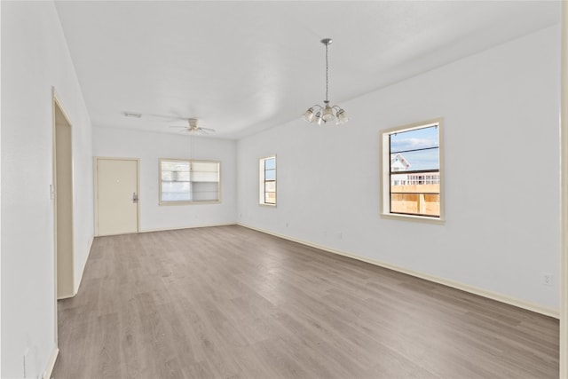 1522 Seawall Blvd, Galveston, TX 77550 - unfurnished room with plenty of natural light, light wood-style flooring, a ceiling fan, and a chandelier