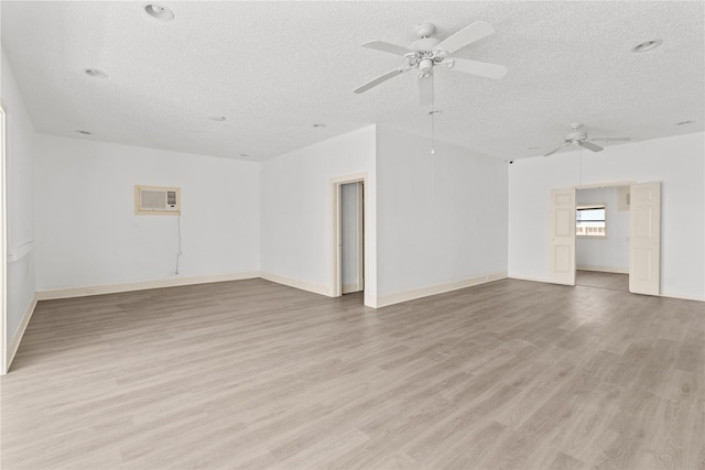 1522 Seawall Blvd, Galveston, TX 77550 - unfurnished room featuring a textured ceiling, ceiling fan, light wood-style flooring, and a wall mounted AC