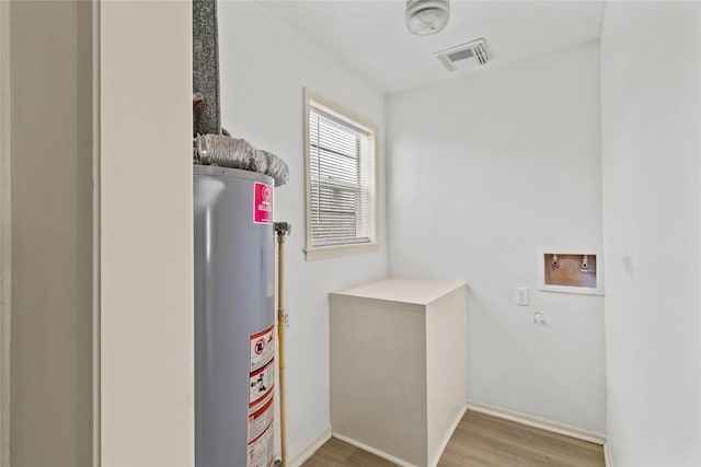 1522 Seawall Blvd, Galveston, TX 77550 - laundry room with gas water heater, hookup for a washing machine, and wood finished floors