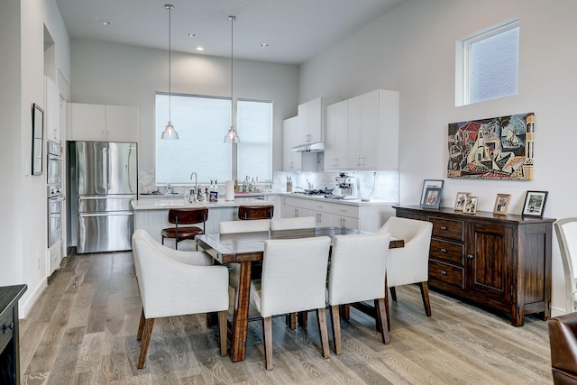 1203 Hickory St Unit D, Houston, TX 77007 - dining area featuring a high ceiling, light wood-style floors, and recessed lighting