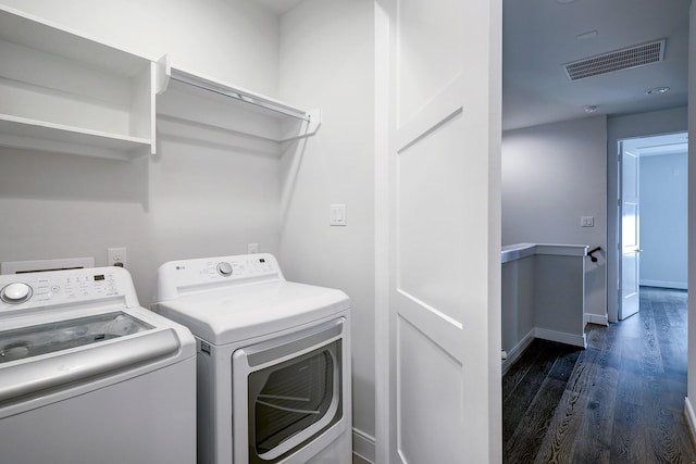 1203 Hickory St Unit D, Houston, TX 77007 - laundry area with dark wood-style flooring, washing machine and clothes dryer, and baseboards