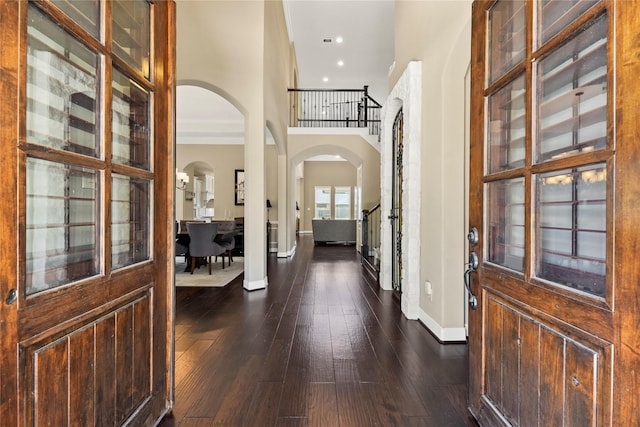 27710 Bering Crossing Dr, Katy, TX 77494 - entrance foyer with arched walkways, baseboards, dark wood finished floors, recessed lighting, and a towering ceiling