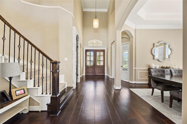 27710 Bering Crossing Dr, Katy, TX 77494 - entrance foyer featuring arched walkways, hardwood / wood-style flooring, stairway, a towering ceiling, and baseboards
