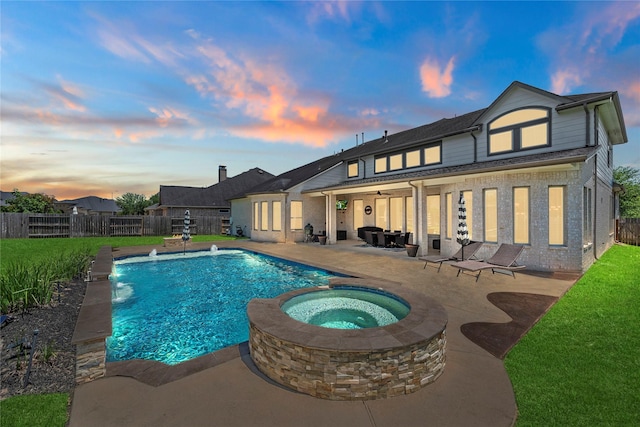 27710 Bering Crossing Dr, Katy, TX 77494 - rear view of house with a patio, a fenced backyard, brick siding, and a pool with connected hot tub