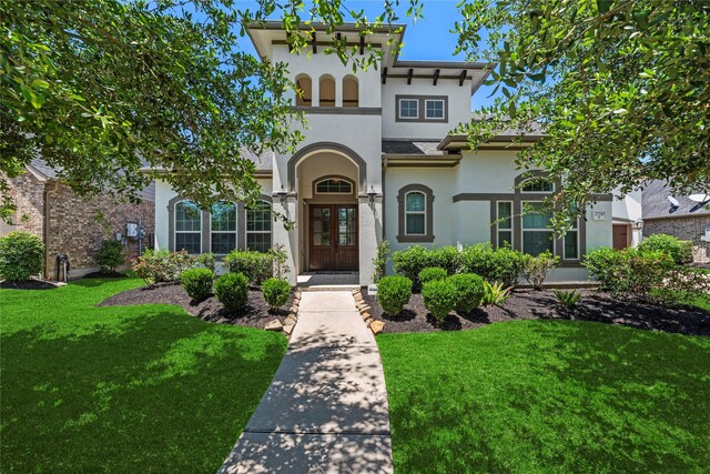 27710 Bering Crossing Dr, Katy, TX 77494 - view of front of house featuring stucco siding, a front lawn, and french doors