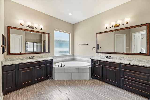 27710 Bering Crossing Dr, Katy, TX 77494 - bathroom featuring two vanities, a stall shower, a bath, and tile patterned flooring