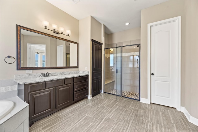 27710 Bering Crossing Dr, Katy, TX 77494 - bathroom with a stall shower, a bath, vanity, baseboards, and recessed lighting