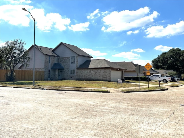 11703 Glenwolde Dr, Houston, TX 77099 - view of front of house with an attached garage, brick siding, and a residential view