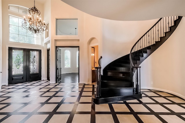 3322 Mallard Run Ct, Katy, TX 77494 - entryway featuring stairs, inlaid floor details, a chandelier, a high ceiling, and baseboards