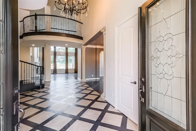 3322 Mallard Run Ct, Katy, TX 77494 - foyer entrance featuring arched walkways, inlaid floor details, a chandelier, decorative columns, and a high ceiling