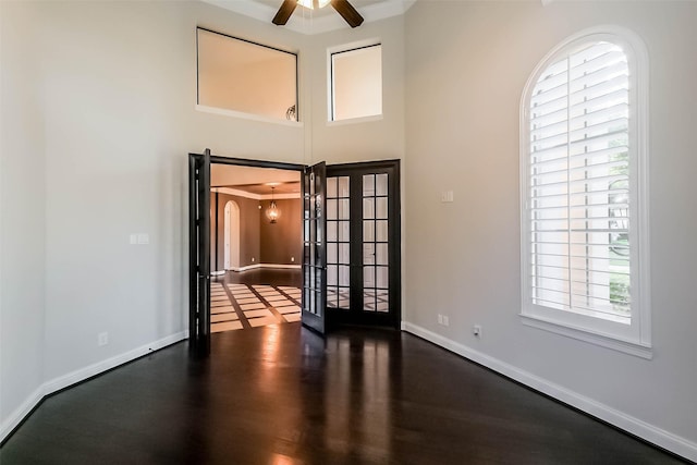 3322 Mallard Run Ct, Katy, TX 77494 - spare room with french doors, wood finished floors, ceiling fan, baseboards, and arched walkways