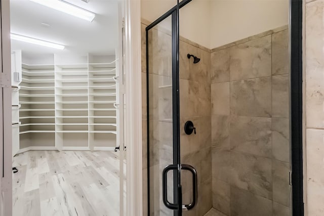 3322 Mallard Run Ct, Katy, TX 77494 - bathroom featuring a shower stall, wood finished floors, and a walk in closet