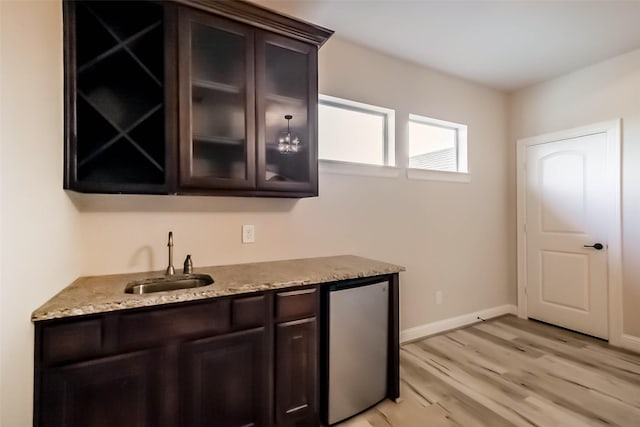 3322 Mallard Run Ct, Katy, TX 77494 - bar featuring fridge, a sink, light wood-style flooring, and baseboards