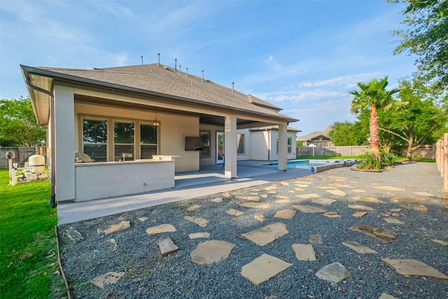 3322 Mallard Run Ct, Katy, TX 77494 - back of property featuring a patio, a fenced backyard, stucco siding, and roof with shingles