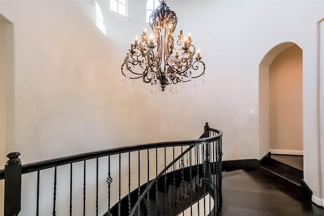 3322 Mallard Run Ct, Katy, TX 77494 - stairway with arched walkways, a chandelier, wood finished floors, and baseboards