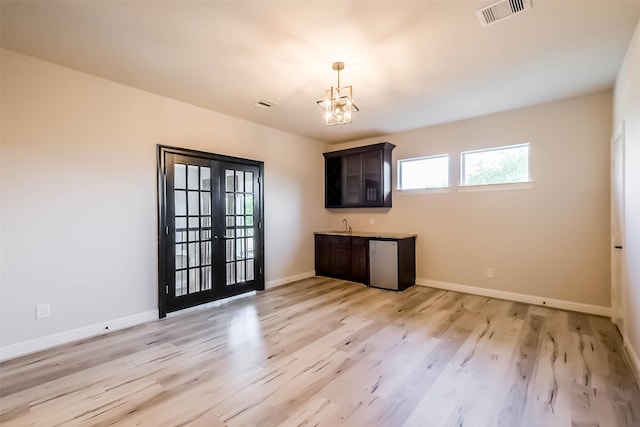 3322 Mallard Run Ct, Katy, TX 77494 - unfurnished living room featuring healthy amount of natural light, light wood finished floors, a chandelier, and baseboards
