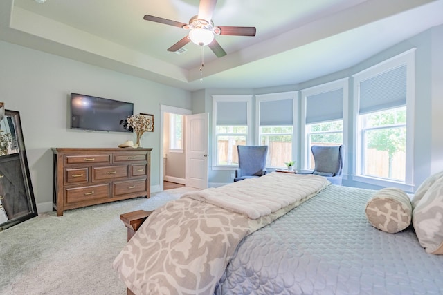 151 Jacks Corner Dr, Montgomery, TX 77316 - bedroom with baseboards, light colored carpet, a tray ceiling, and a ceiling fan