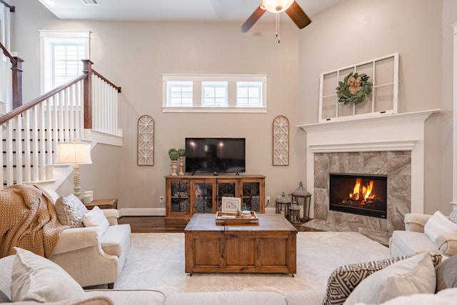 151 Jacks Corner Dr, Montgomery, TX 77316 - living room featuring plenty of natural light, wood finished floors, a towering ceiling, ceiling fan, and a tiled fireplace