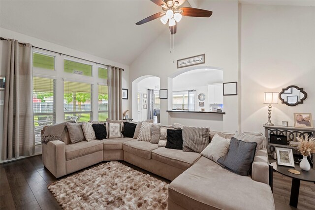 2506 Abernathy Glen Ct, Houston, TX 77014 - living area with high vaulted ceiling, ceiling fan, dark wood-style flooring, arched walkways, and plenty of natural light